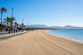 Quiet beach promenade during the off-season with only a few joggers and an empty coastline under a clear blue sky