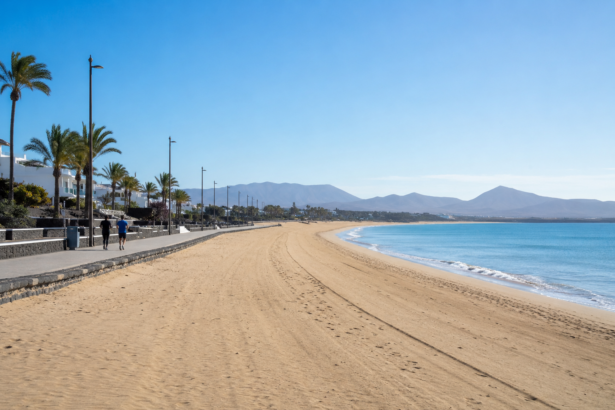 Quiet beach promenade during the off-season with only a few joggers and an empty coastline under a clear blue sky