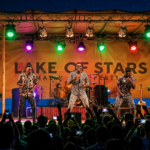 Lake of Stars music festival in Malawi with performers on stage and a crowd in front of Lake Malawi