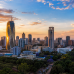 Modern skyline of Nairobi, Kenya, at sunset with contemporary high-rise buildings and green urban spaces.