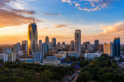 Modern skyline of Nairobi, Kenya, at sunset with contemporary high-rise buildings and green urban spaces.